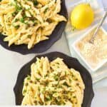 Overhead view of Greek pasta with lemon sauce on plates.