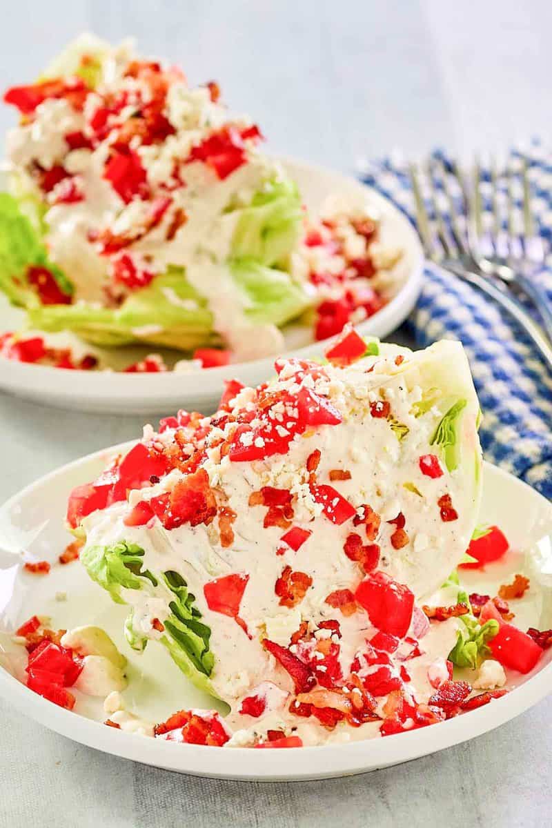 Maytag buttermilk blue cheese dressing and chopped tomatoes on iceberg lettuce wedges.