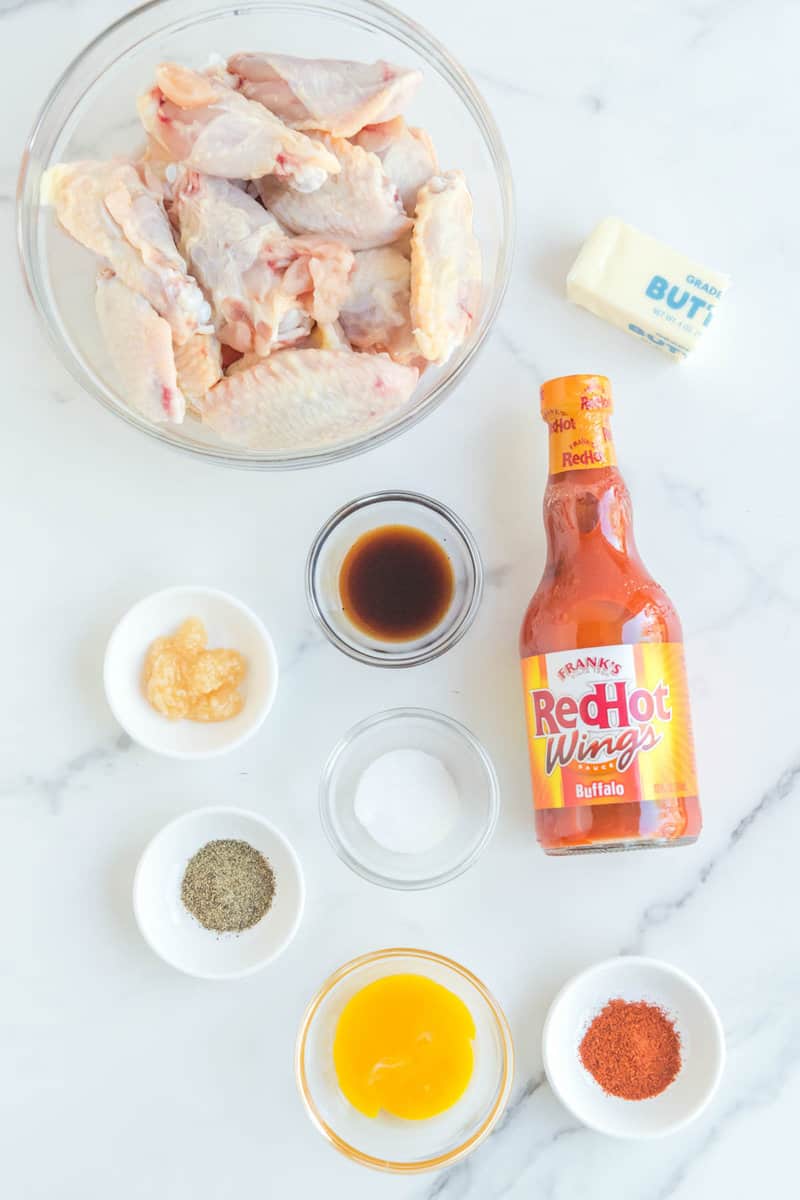 Copycat Buffalo Wild Wings Buffalo wings ingredients on a marble surface.