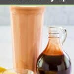 Homemade chocolate syrup in a small glass pitcher and a glass of chocolate milk.