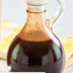 Homemade chocolate syrup in a small glass pitcher.