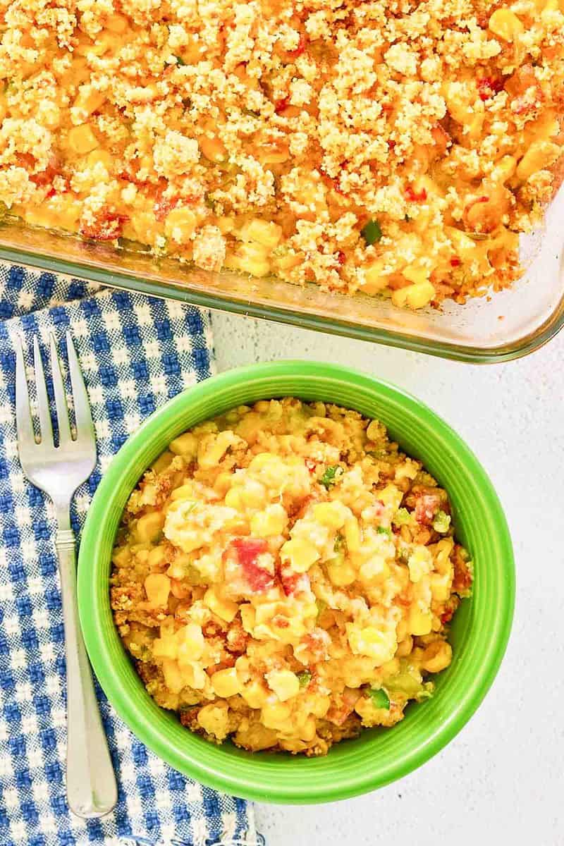 Overhead view of copycat Luby's Spanish Indian baked corn casserole in a bowl and baking dish.