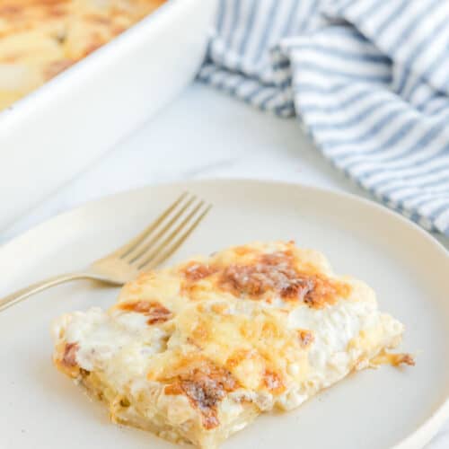 Potato au gratin on a plate and in a baking dish.