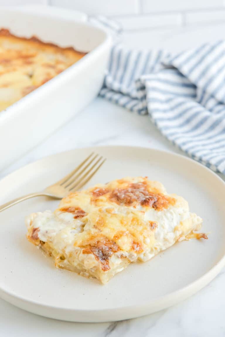 Potato au gratin on a plate and in a baking dish.