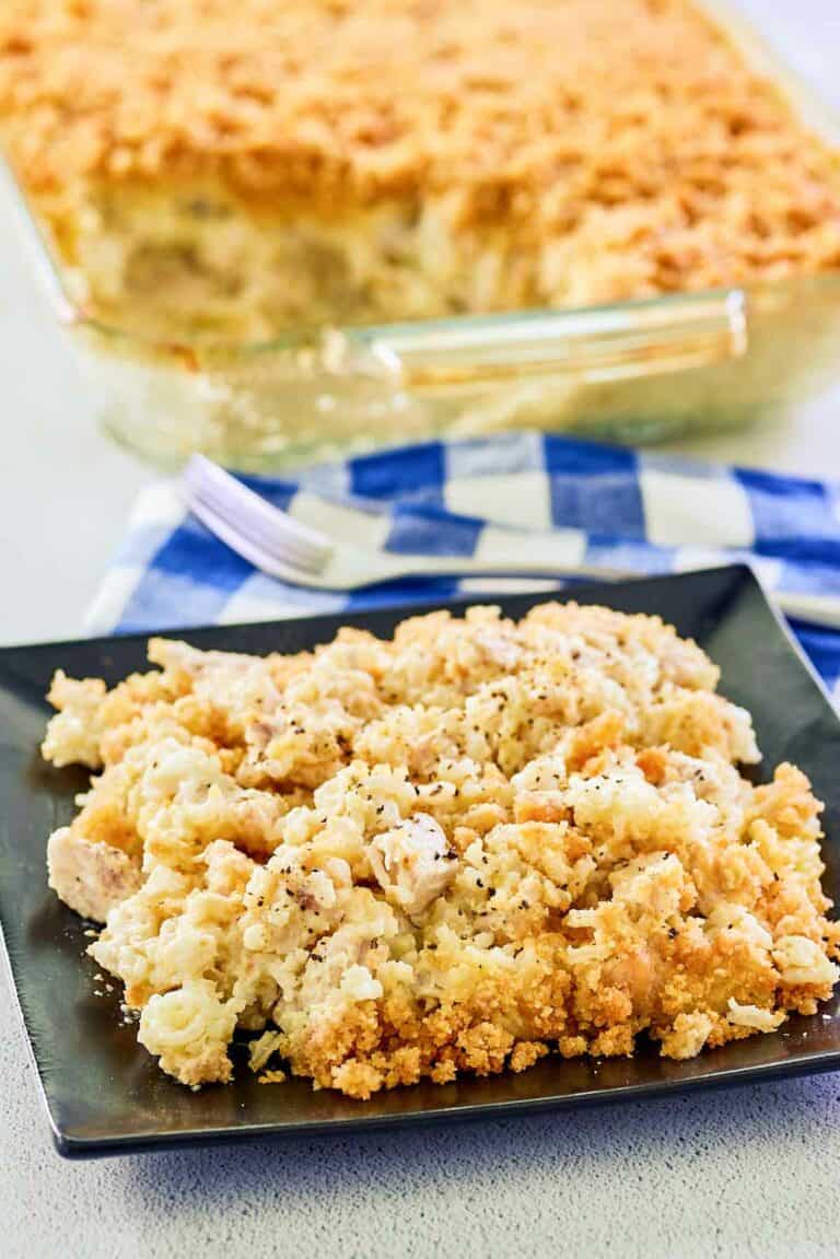 Ritz cracker chicken casserole in a glass baking dish and a serving on a plate.
