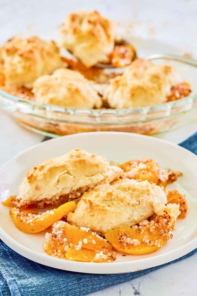 Bisquick peach cobbler on a plate and in a pie plate.