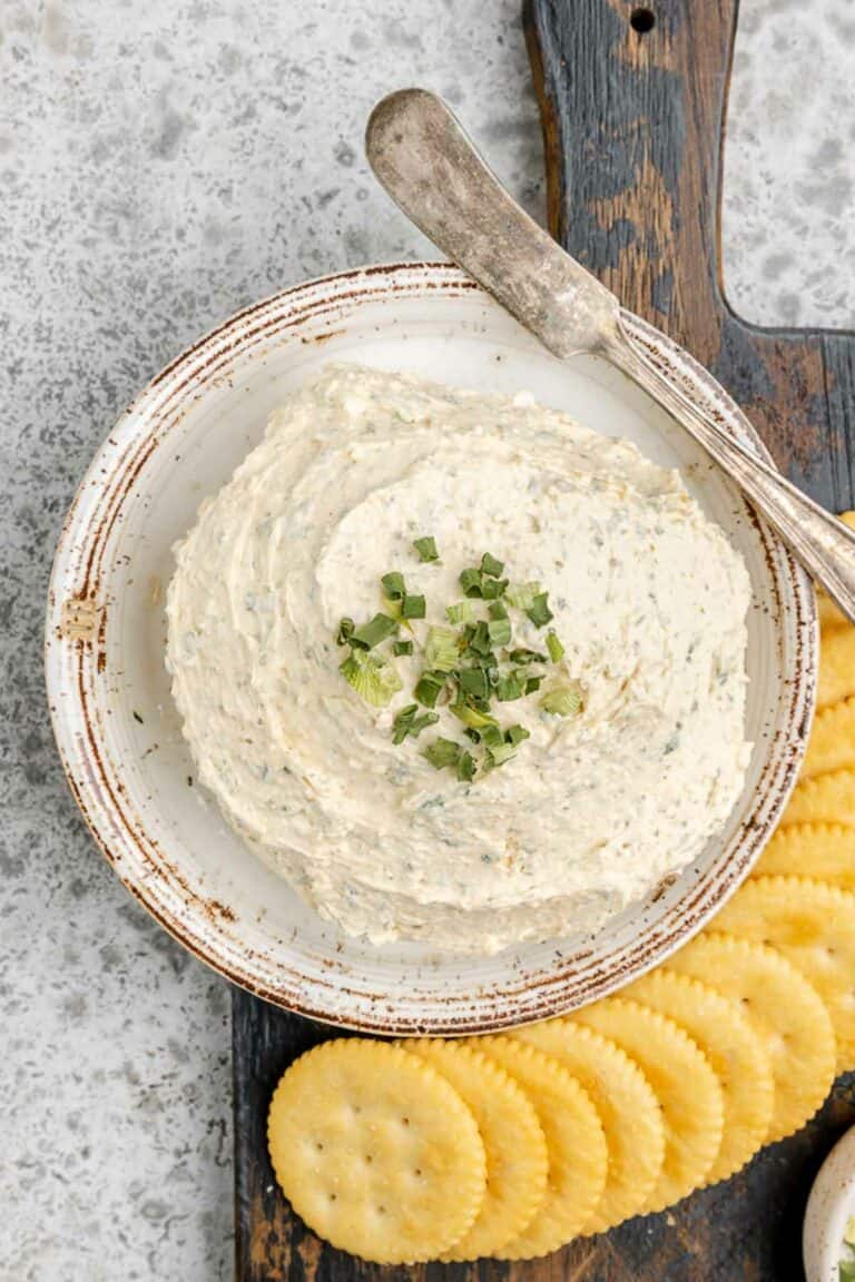 Overhead view of homemade boursin cheese and crackers next to it.