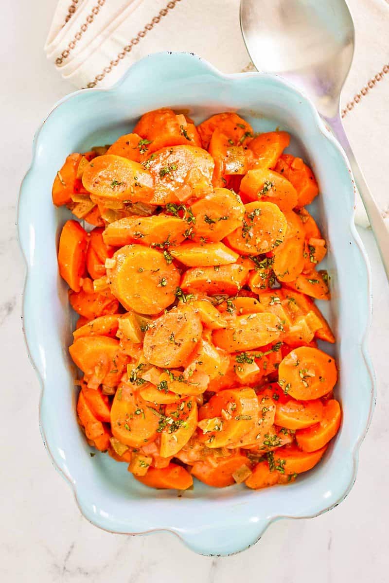 Overhead view of copper penny carrots in a serving dish.