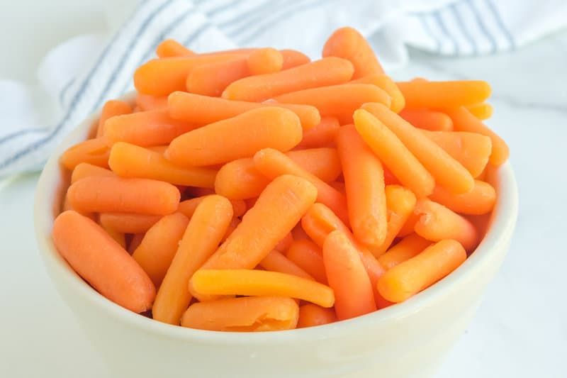 a bowl of glazed baby carrots