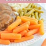 Homemade Cracker Barrel baby carrots on a plate with chopped steak, green beans, and mashed potatoes.