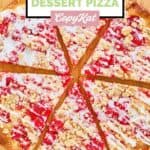 Overhead view of homemade cherry pizza on a wood board.