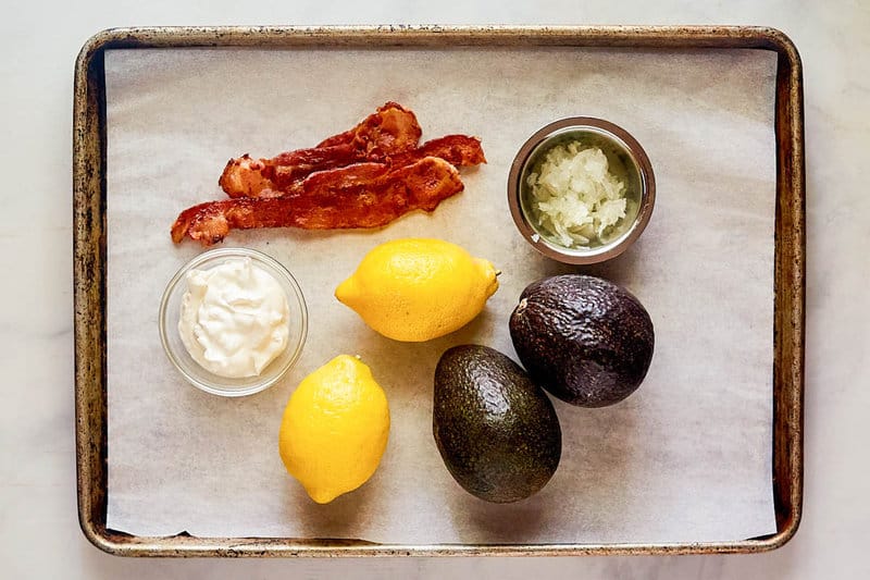 Avocado dip ingredients on a tray.