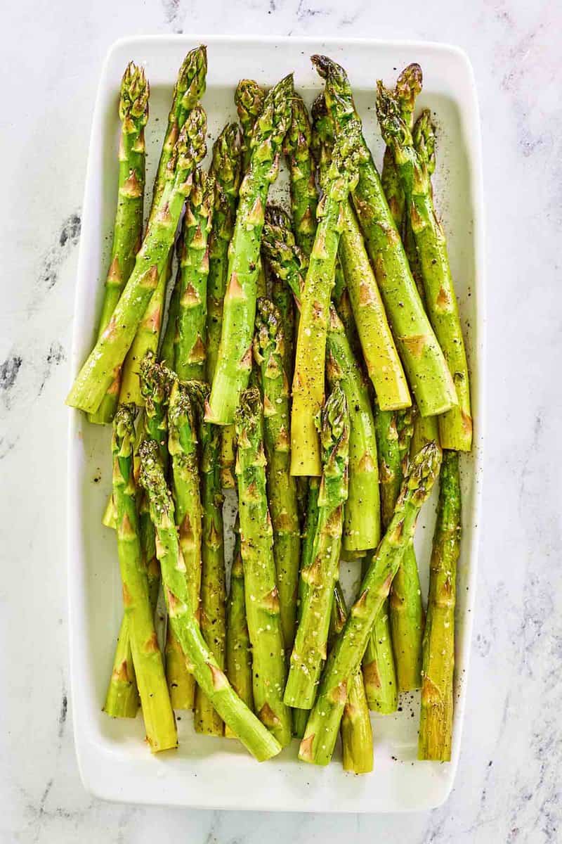 Overhead view of oven roasted asparagus on a platter.