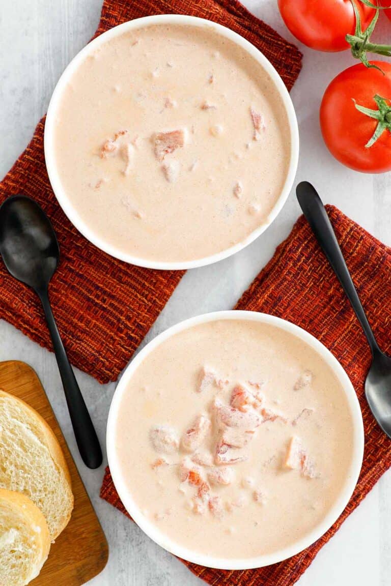 Overhead view of copycat 4B's creamy tomato soup in two bowls.