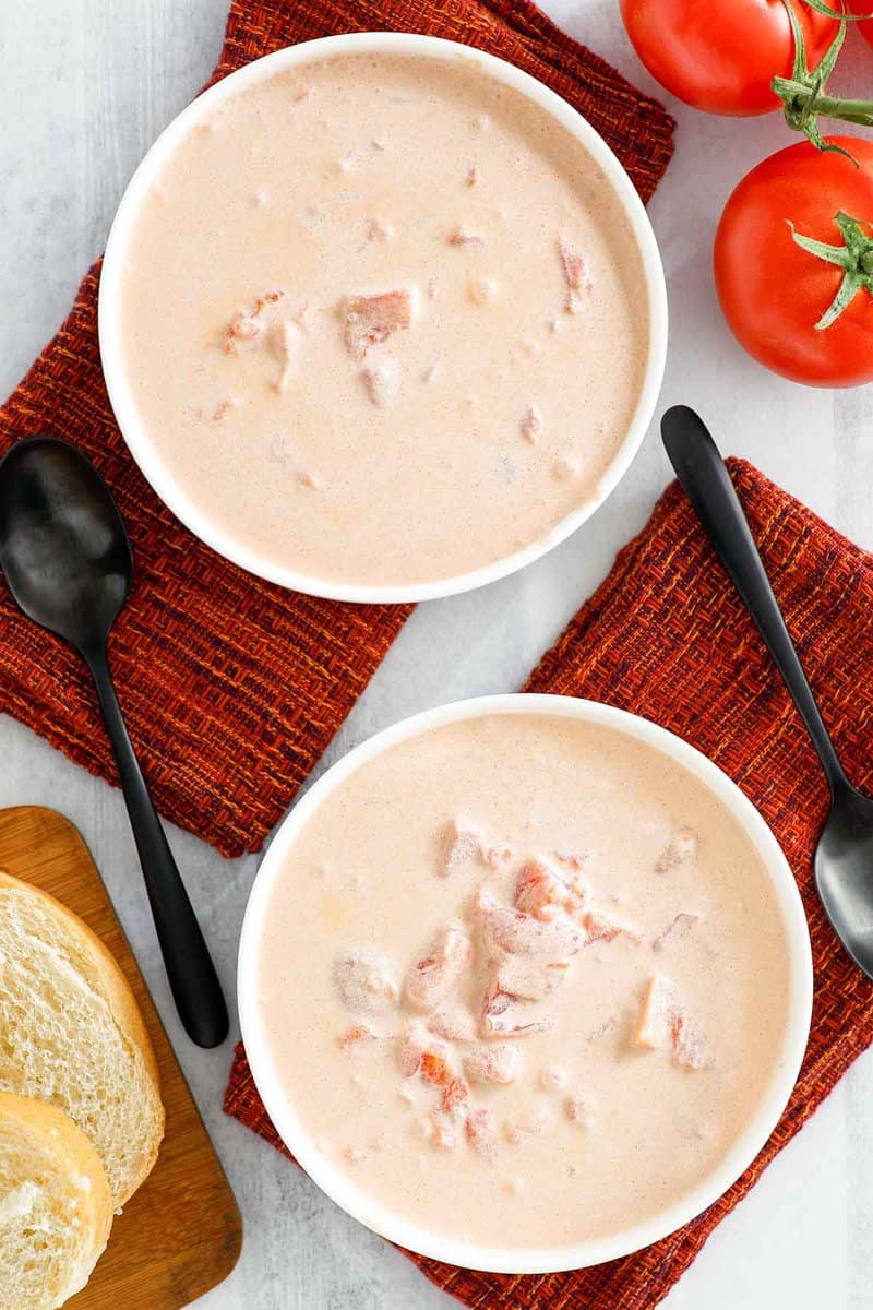 Overhead view of copycat 4B's creamy tomato soup in two bowls.
