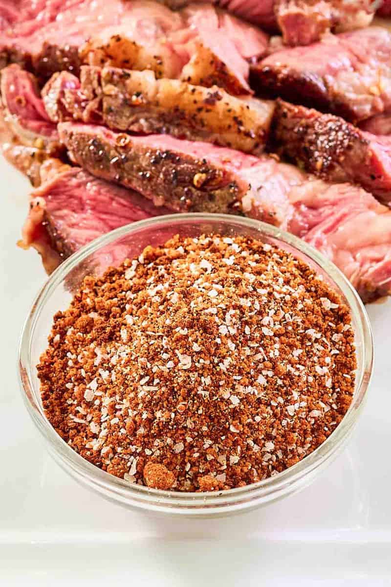Homemade coffee rub and steak on a platter.