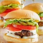 Closeup of a homemade Culver's butter burger on a wood serving board.