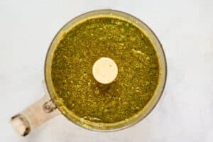 Vegetable and tomato mixture in a food processor.
