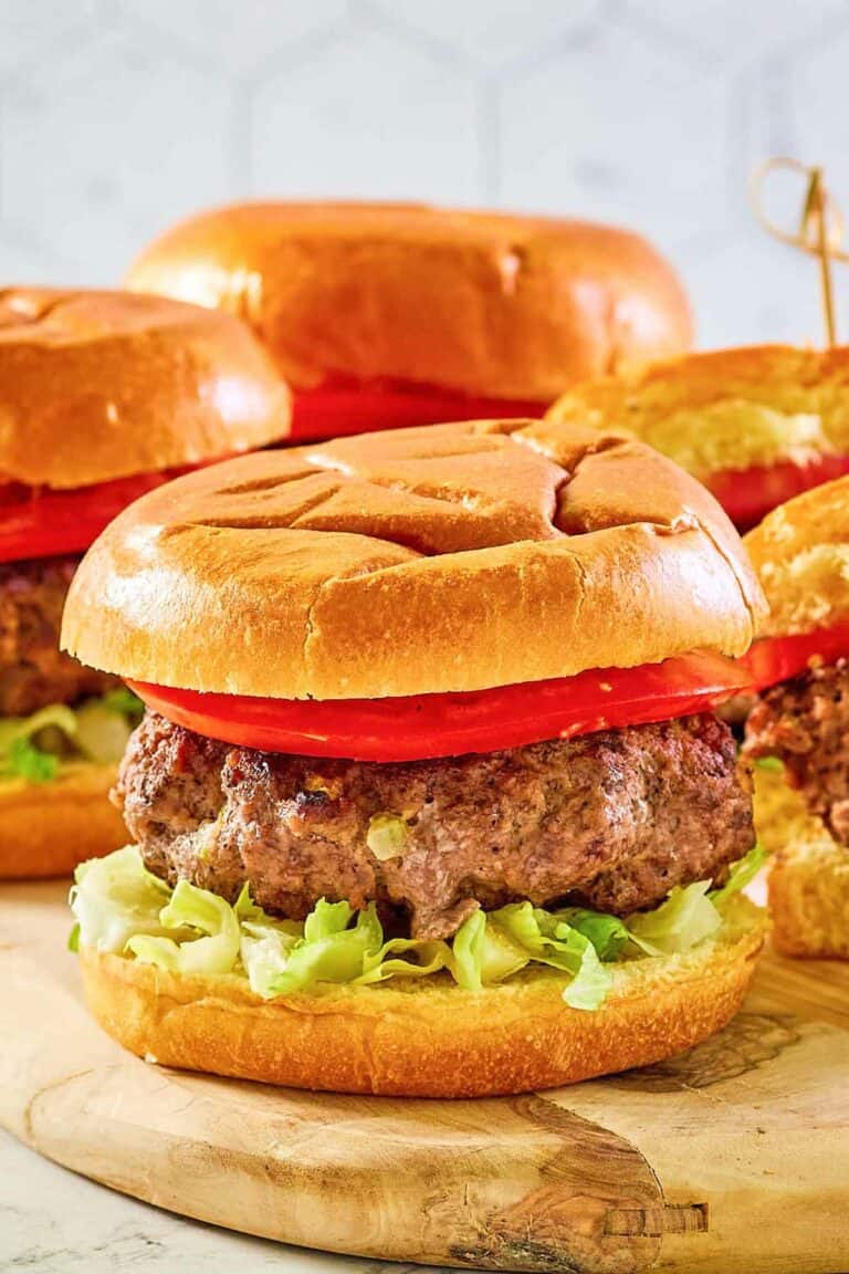 Copycat 21 Club burger on a wood board.