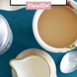 Overhead view of a cup of coffee and homemade amaretto coffee creamer.