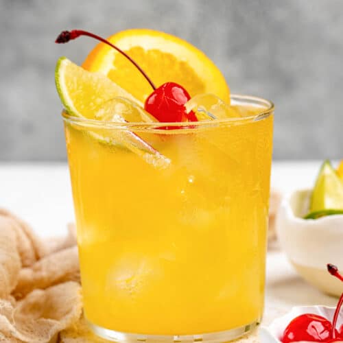 Copycat Applebee's white peach sangria garnished with orange, lime, and a cherry.