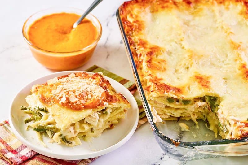Chicken lasagna and a bowl of homemade marinara sauce.