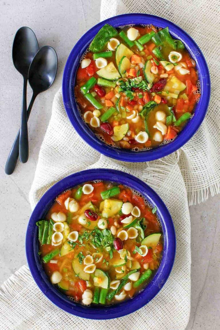 Overhead view of copycat Olive Garden minestrone soup in two bowls.