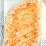 Overhead view of homemade Pizza Hut cheese sticks on a white platter.