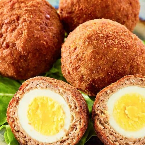 Scotch eggs on a plate.