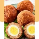 Scotch eggs on a plate.