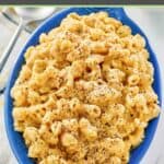 A serving of homemade mac and cheese with black pepper sprinkled on top.