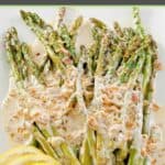 A platter with sauteed asparagus spears covered in lemon cream sauce.