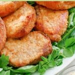 Homemade shake and bake pork chops and lettuce on a platter.
