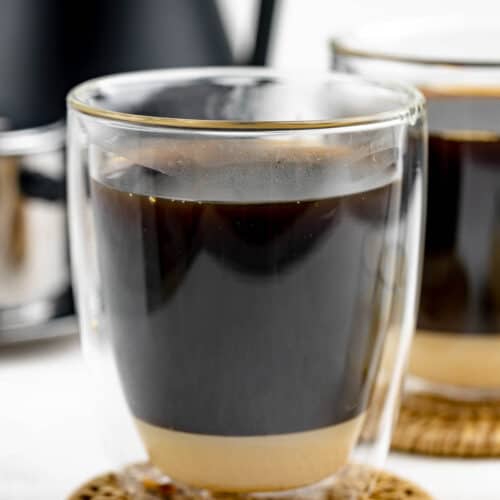 Vietnamese coffee in a mug on top of a coaster.