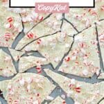 Homemade Williams Sonoma peppermint bark candy pieces scattered on a marble surface.