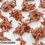 Chocolate butterscotch haystack cookies scattered on parchment paper.