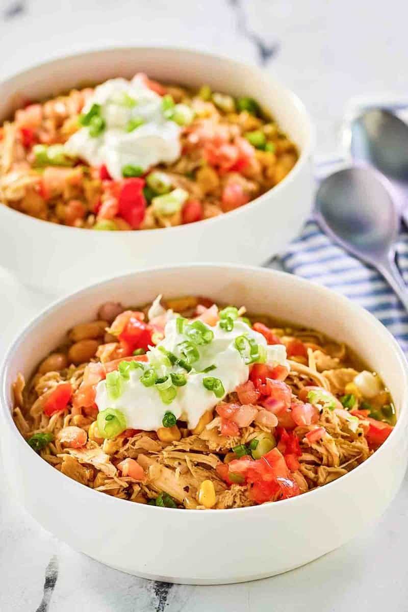 Crockpot white chicken chili in two bowls.