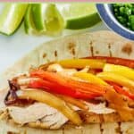Grilled chicken fajita on a tortilla.