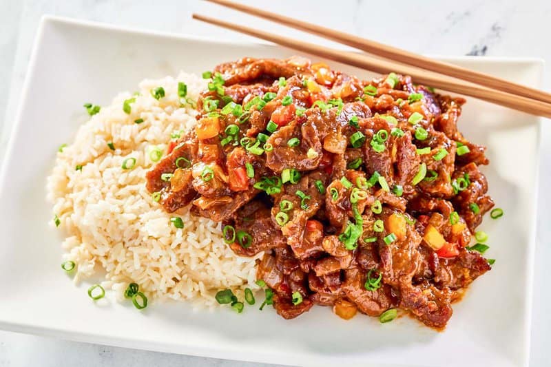 Copycat Panda Express Beijing beef with rice on a plate.