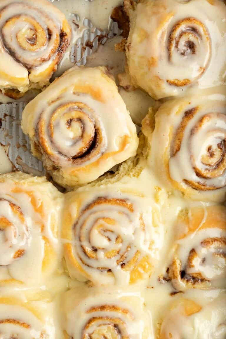 Copycat cinnamon rolls with frosting in a baking pan.