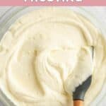 Homemade Cinnabon frosting in a glass mixing bowl.