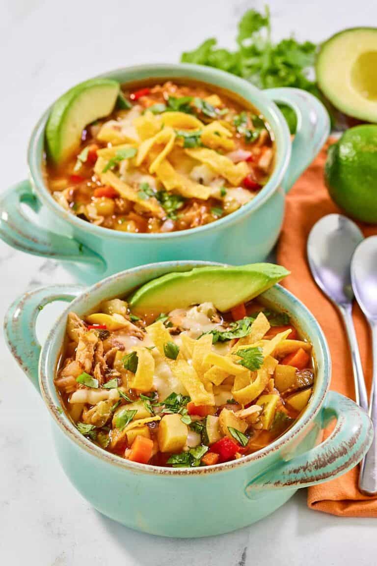 Copycat El Torito's chicken tortilla soup in two bowls.