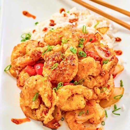 Copycat Panda Express chili crisp shrimp and white rice on a plate.