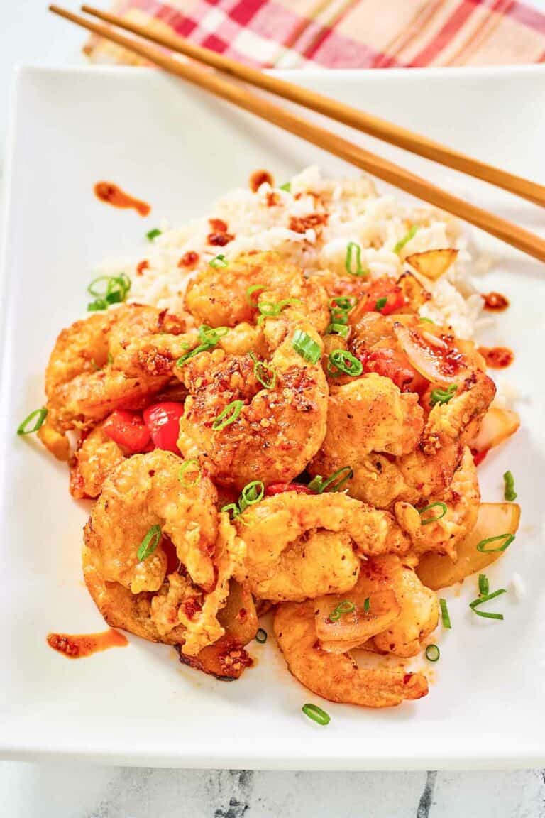 Copycat Panda Express chili crisp shrimp and white rice on a plate.