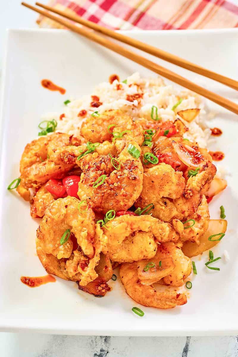 Copycat Panda Express chili crisp shrimp and white rice on a plate.