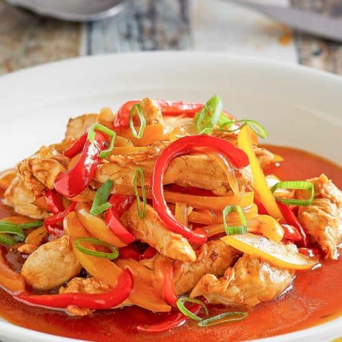 Copycat Panda Express firecracker chicken in a bowl and a spoon behind it.