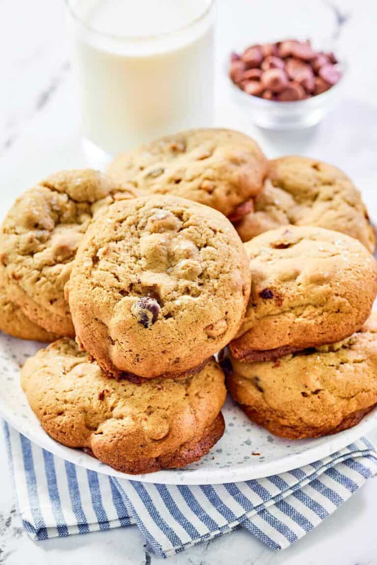 Copycat Panera kitchen sink cookies on a plate and a glass of milk behind it.