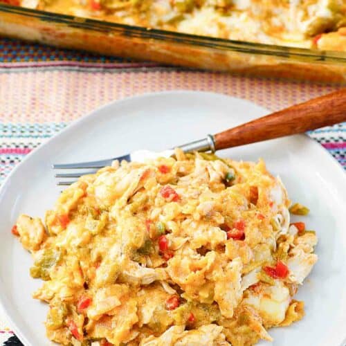 King ranch casserole in a baking dish and a serving on a plate.