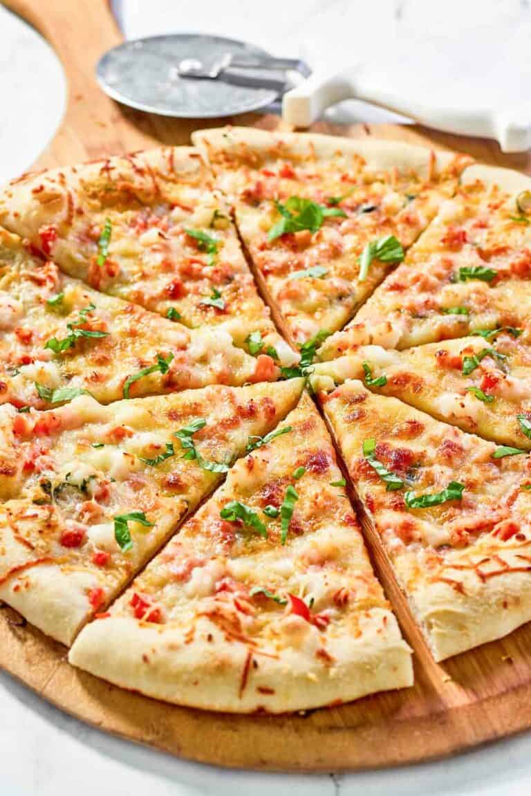 Copycat Red Lobster lobster pizza and a pizza cutter.