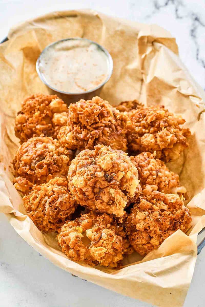 Copycat Texas Roadhouse rattlesnake bites and cajun sauce in a serving basket.